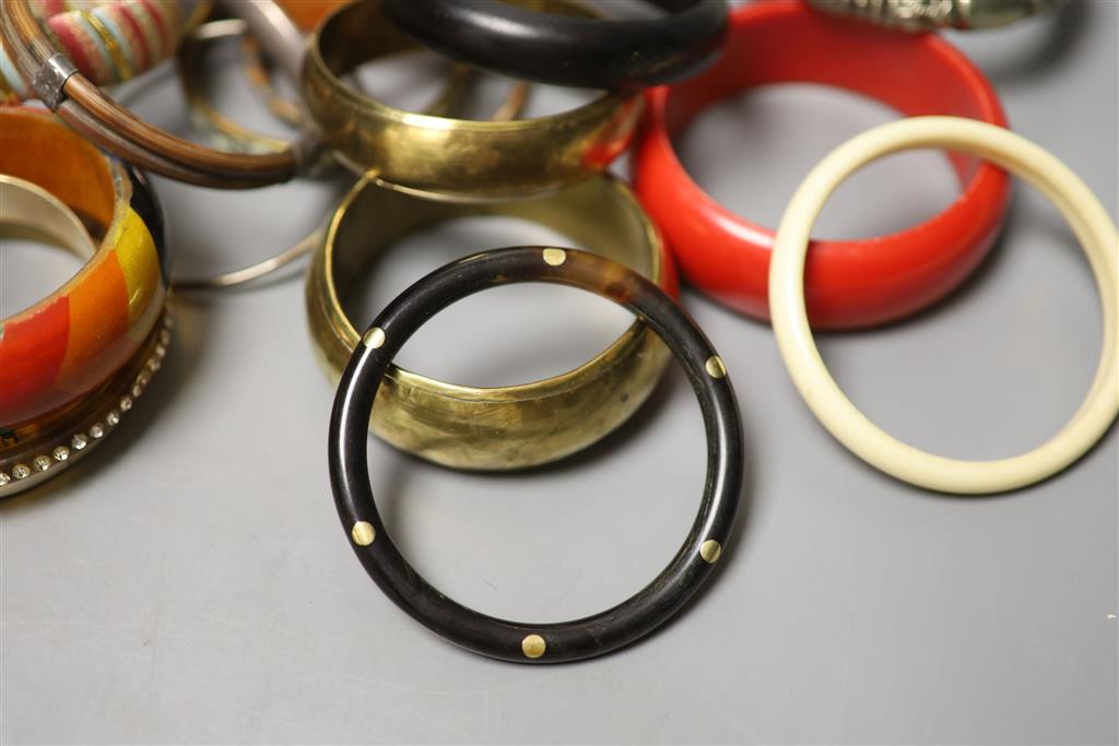 A collection of bangles, including five ethnic white metal examples,